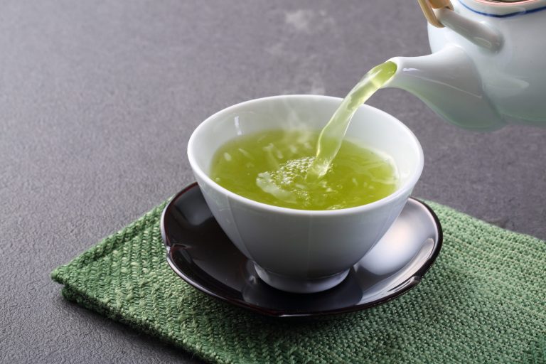 Green Tea being poured in a cup