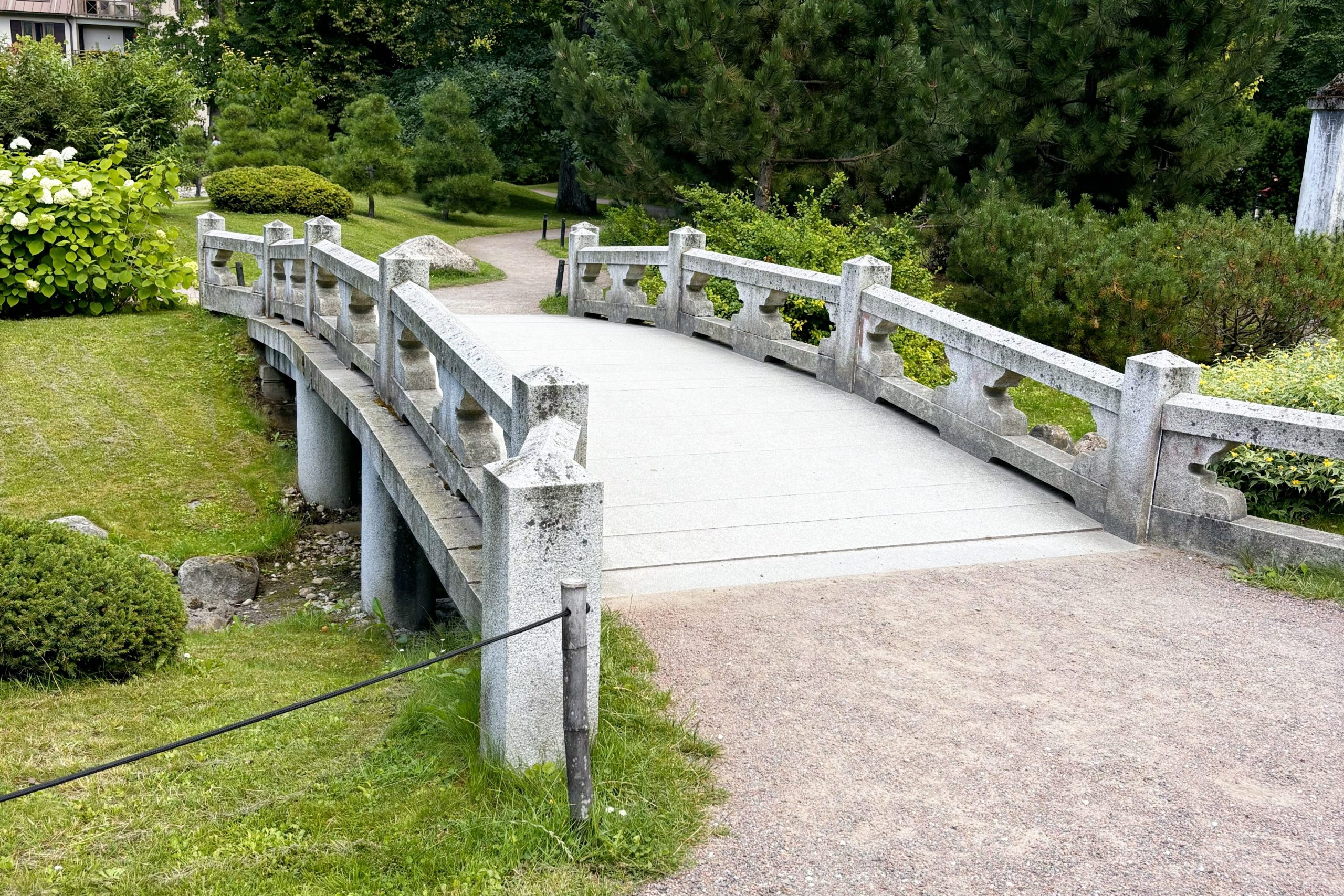 A striking portrait of a woman with a sleek, platinum blonde bob against a black background. Her hair is smooth and glossy, styled to perfection, and paired with flawless makeup and bold pink lipstick. The image showcases professional hair colouring and modern styling, reflecting the premium services offered at Honeys Hair & Beauty in Taunton.